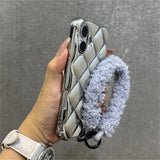 Silver quilted phone case with fluffy strap.
