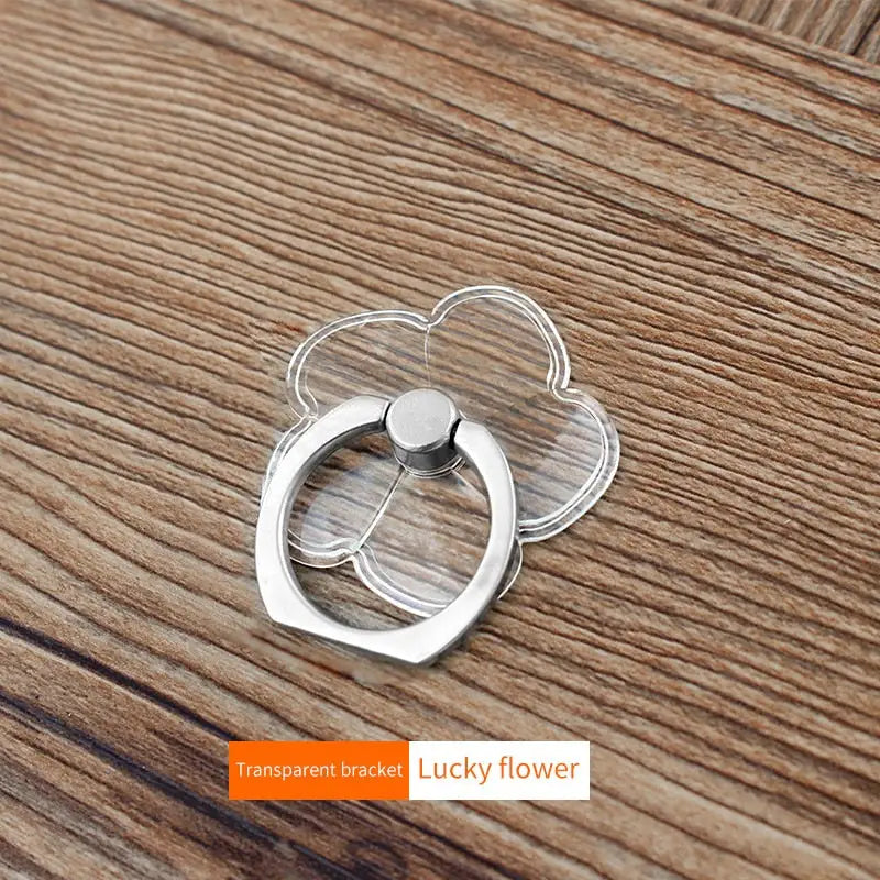 a silver ring on a wooden table