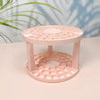 a pink candle holder on a table