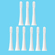 six white toothbrushes with white bristles on a white background