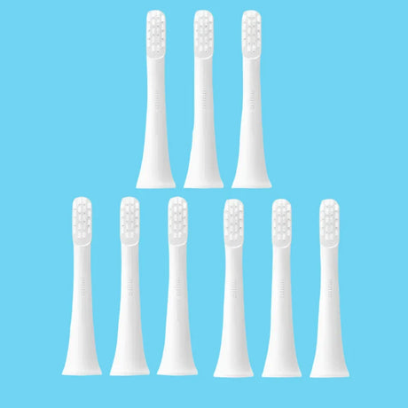 six white toothbrushes with white bristles on a white background