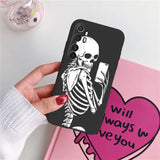 a skeleton holding a heart phone case