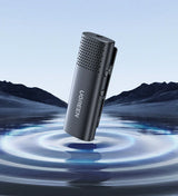 Sleek black microphone or audio recording device with a perforated top half.