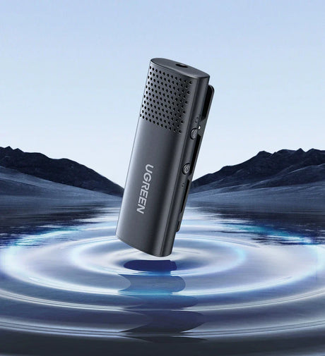 Sleek black microphone or audio recording device with a perforated top half.