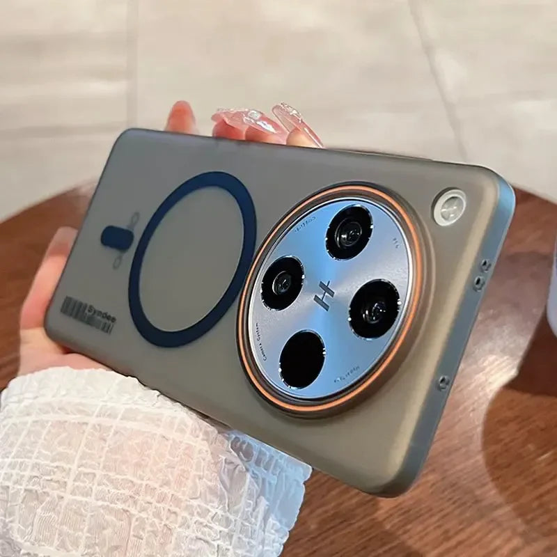 A sleek, grey smartphone in a protective case with a prominent circular camera module and a magnetic charging ring.