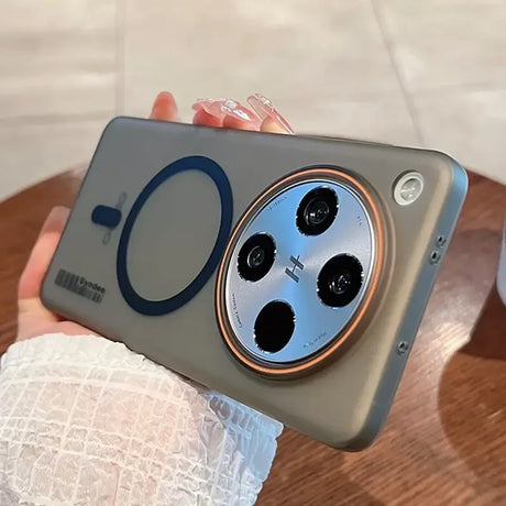A sleek, grey smartphone in a protective case with a prominent circular camera module and a magnetic charging ring.