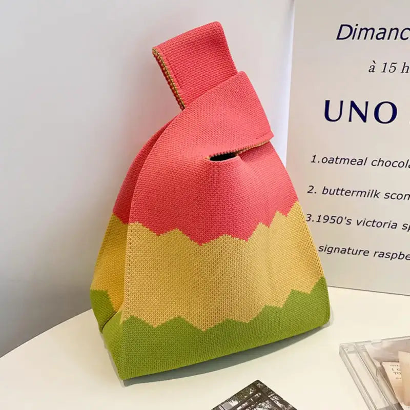 a small bag with a pink and yellow design
