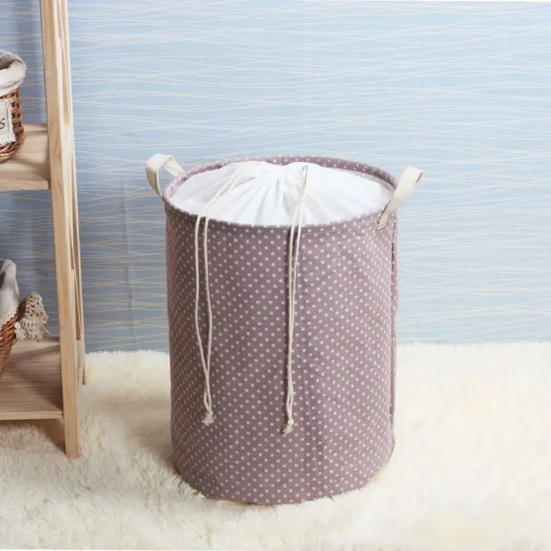 a small laundry basket with a white polka dot pattern