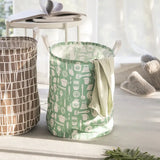 a green and white laundry basket with a white handle