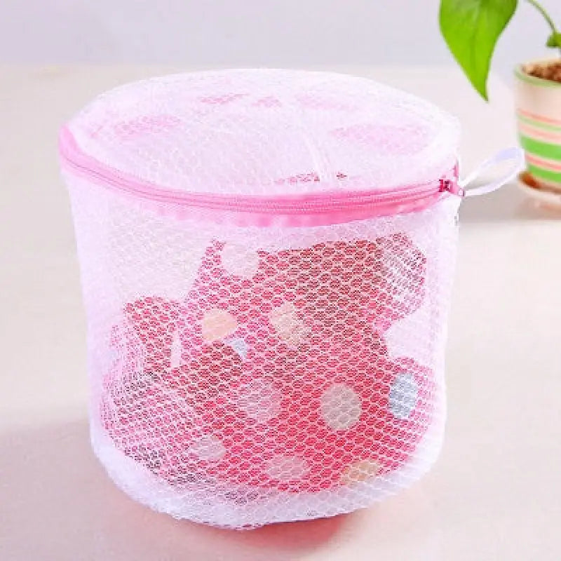 a pink mesh bag with a small flower inside