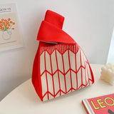 a small red and white bag sitting on a table
