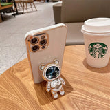 there is a small robot that is sitting next to a cup of coffee