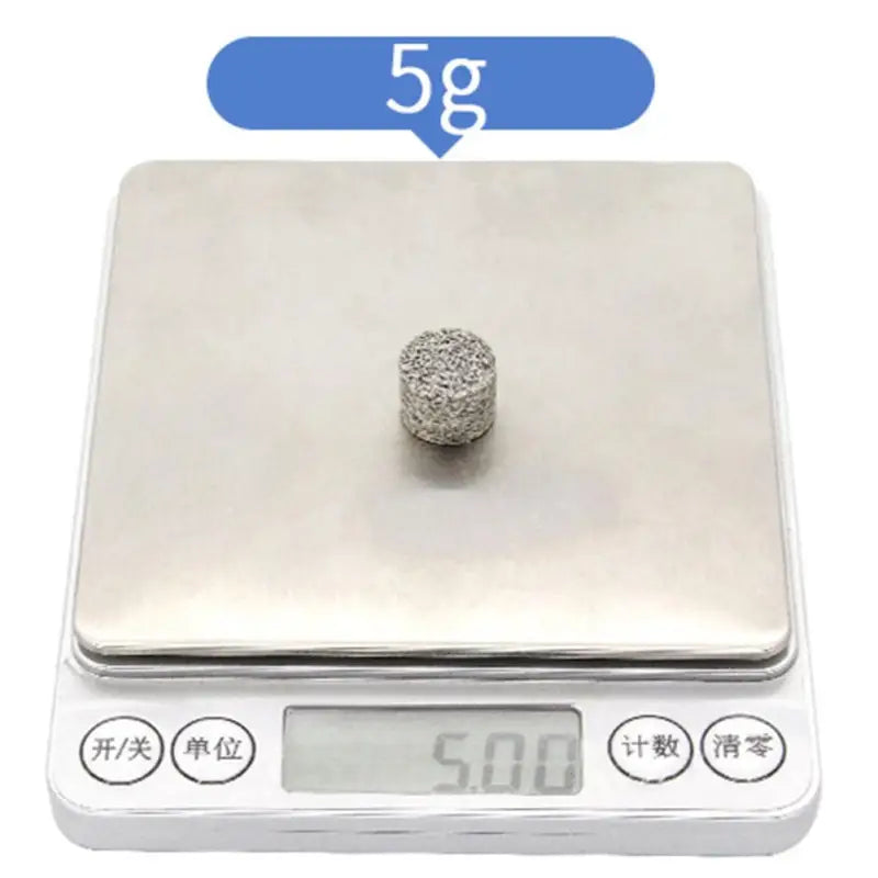 a small silver ball on a scale