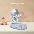 a small silver elephant figurin on a table