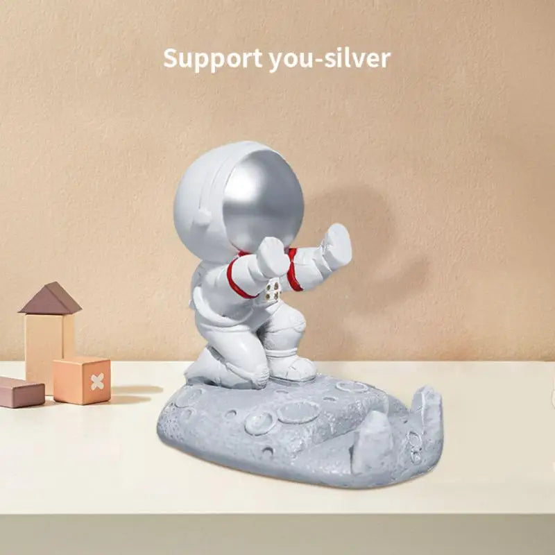 a small silver elephant figurin on a table