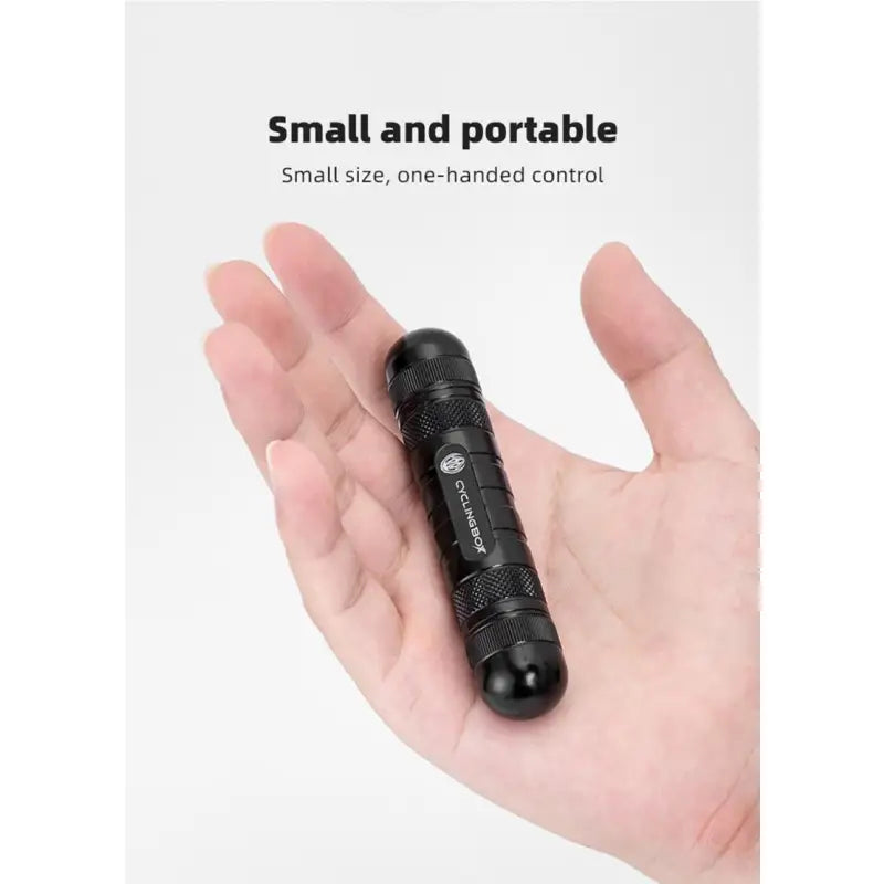a hand holding a small flashlight with the words small portable