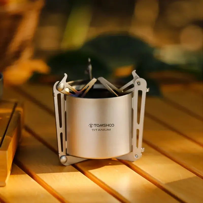 a small stove sitting on top of a wooden table