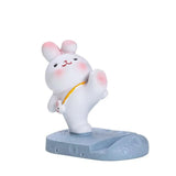 there is a small toy of a white cat on a blue base