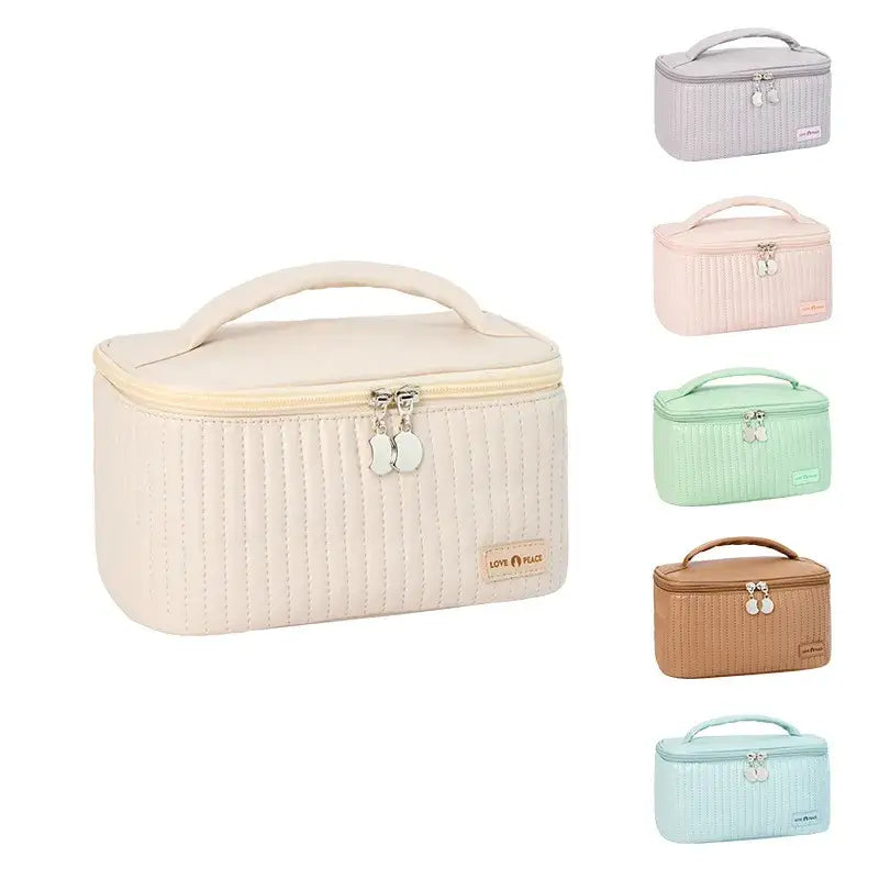 a small white and green cosmetic case with four compartments