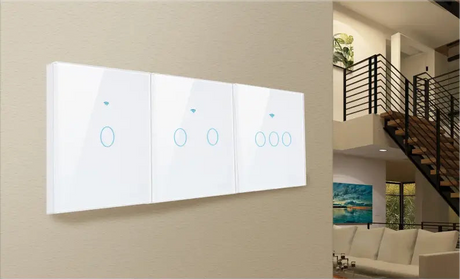 Smart light switch panel with three touch-sensitive controls mounted on a wall.