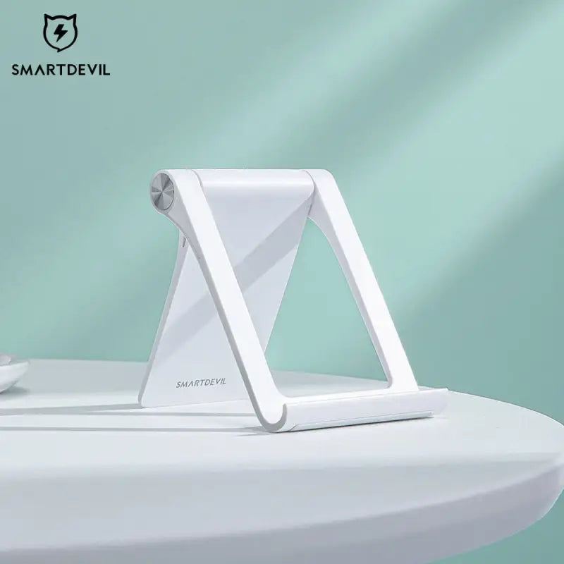 the smart phone stand is on top of a table