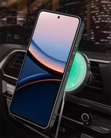 A smartphone with a black case mounted on a car vent charger.
