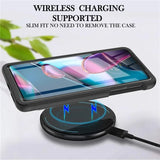 Smartphone in a black protective case, wirelessly charging.
