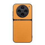 Smartphone with a bright orange leather-textured back panel and a circular quad-camera setup.