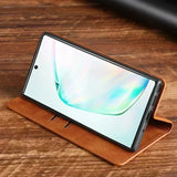 Smartphone in a brown leather folio case displaying a curved blue-green line on its screen.