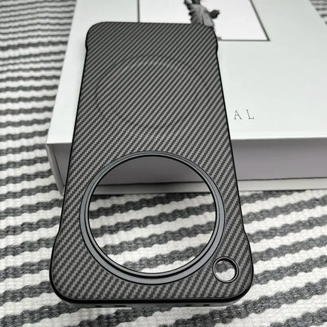 A smartphone case with a carbon fiber texture and a large circular cutout for the camera module.