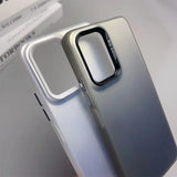 Smartphone case with a gradient silver-to-gray color and raised edges around the camera cutout.