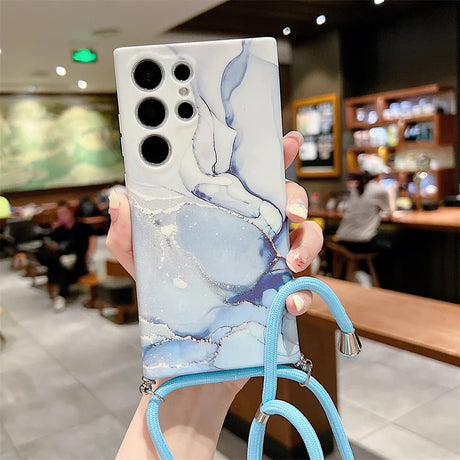 Smartphone case with a marble-like pattern and multiple camera cutouts, featuring an attached blue lanyard.