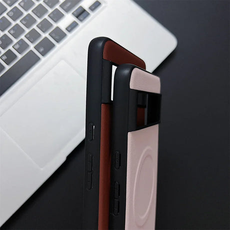 Smartphone cases in black, brown, and pink colors stacked together.