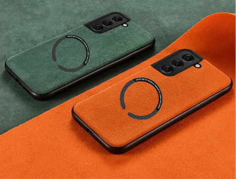 Smartphone cases in green and orange with circular designs and camera cutouts.