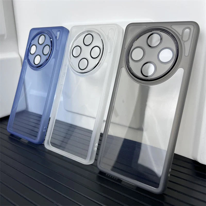 Smartphone cases with prominent circular camera cutouts in blue, white, and gray colors.