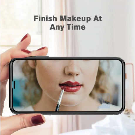 Smartphone displaying a close-up of lips being applied with red lipstick.