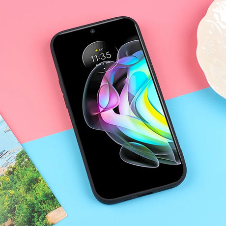 Smartphone displaying a colorful abstract design on its screen.