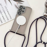 Smartphone in a gray case with a lanyard and a wireless charger.