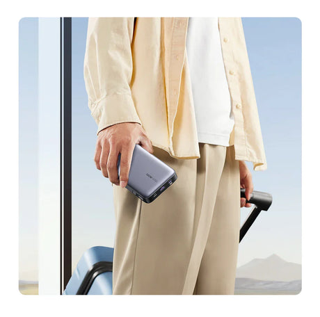 Smartphone held in a person’s hand wearing light-colored clothing.