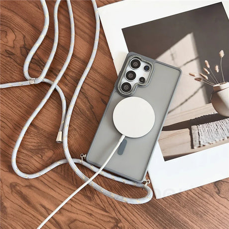 Smartphone with charging pad and crossbody strap.