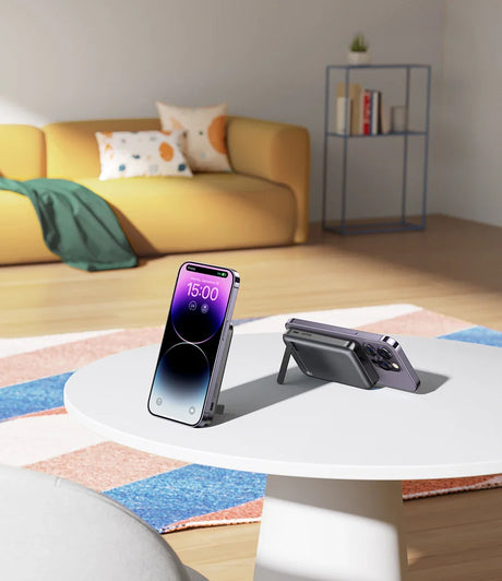 Smartphone propped up on a folding stand on a colorful rug.