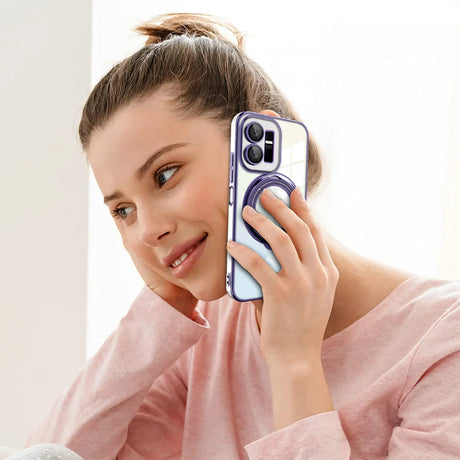 Smartphone with a purple case and multiple camera lenses being held to an ear.