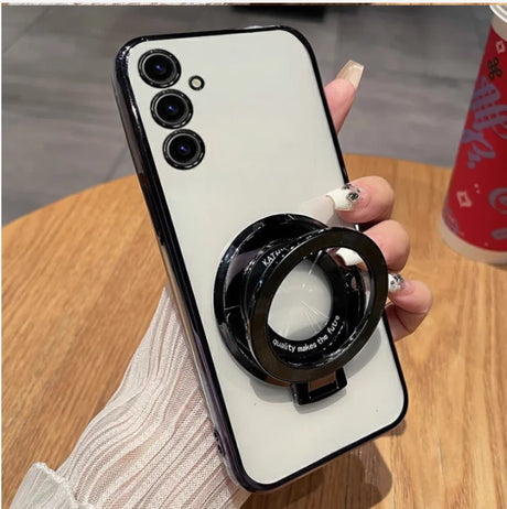 Smartphone with three camera lenses and a circular ring attachment on its back.