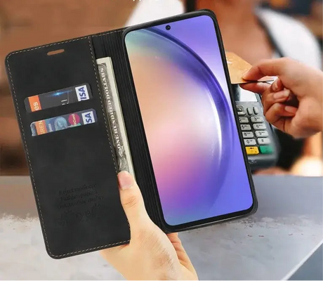 Smartphone in a wallet-style case with card slots and a payment terminal nearby.