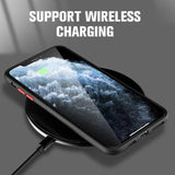 Smartphone on a wireless charging pad with a stormy ocean wallpaper displayed on its screen.