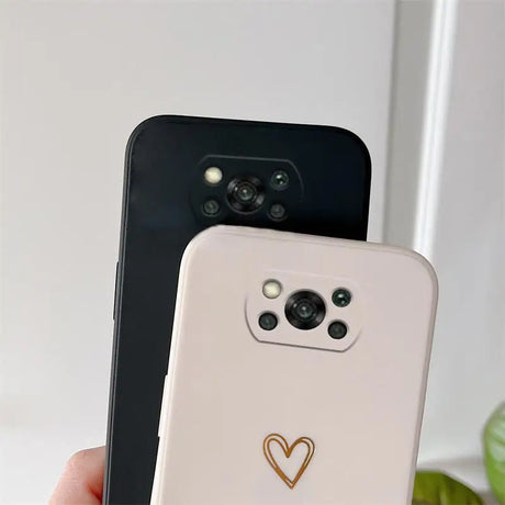 a person holding a phone with a heart on it