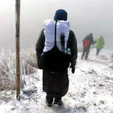 a man walking down a snowy path