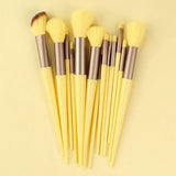 a set of makeup brushes on a yellow background