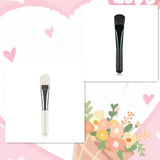 a brush and a flower on a pink background