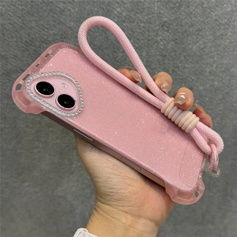Sparkly pink iPhone case with a wrist strap and jeweled camera cutout.